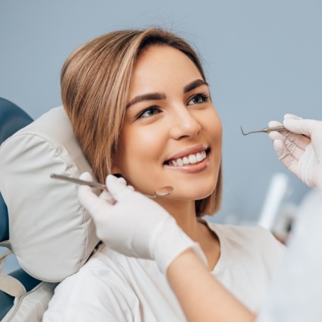 Woman smiling at her dentist during dental checkup