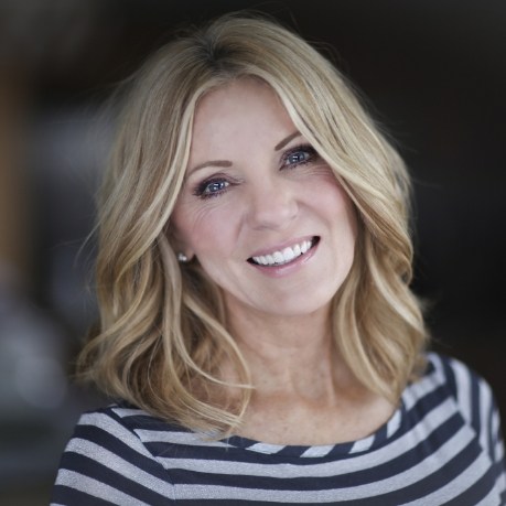 BLonde woman in striped blouse smiling