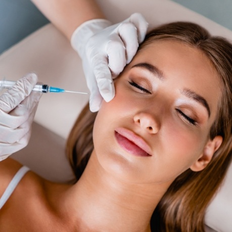 Woman receiving a Botox injection in her cheek