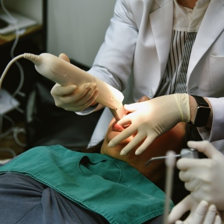 Dental patient having digital impressions of their teeth taken by dentist