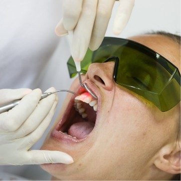 Dental patient receiving laser periodontal therapy