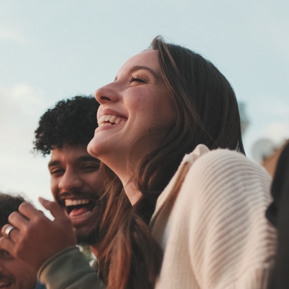 Group of young adults laughing together outdoors