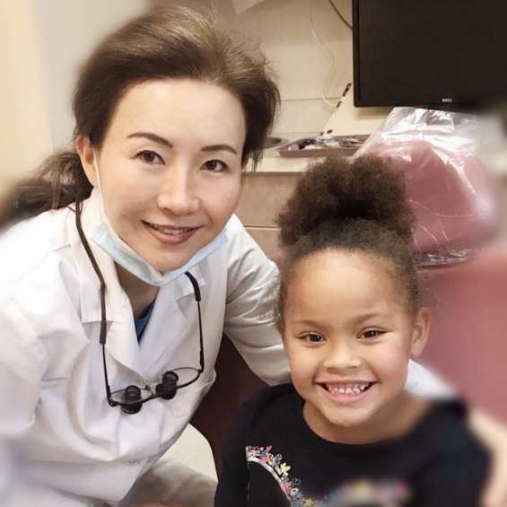 Cherry Hill holistic dentist Doctor Kessy Lee smiling with child patient