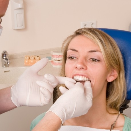 Dentist fitting a patient with Invisalign