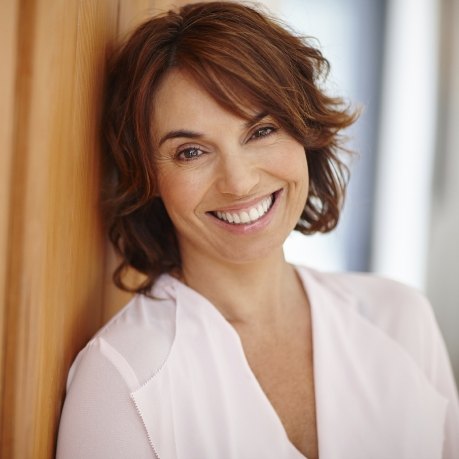 Smiling woman in white collared shirt