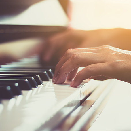 Close up of person playing piano