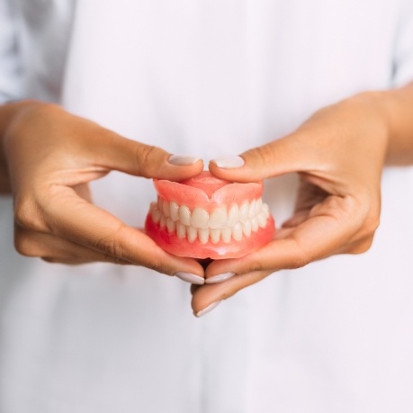 Dentist holding a set of full dentures