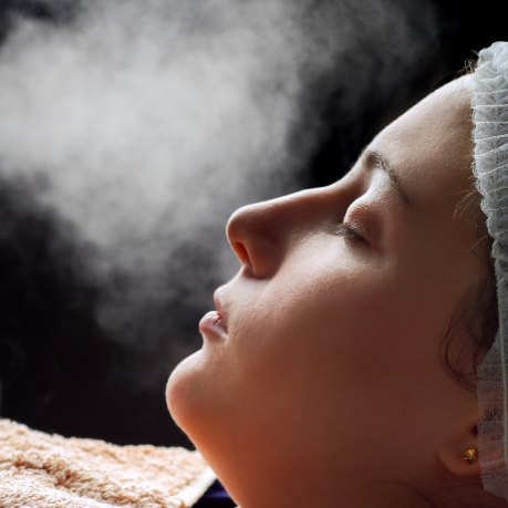 Dental patient having mist sprayed near their face