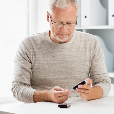 Senior man checking his blood sugar