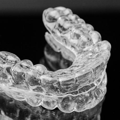 Clear oral appliance against black background
