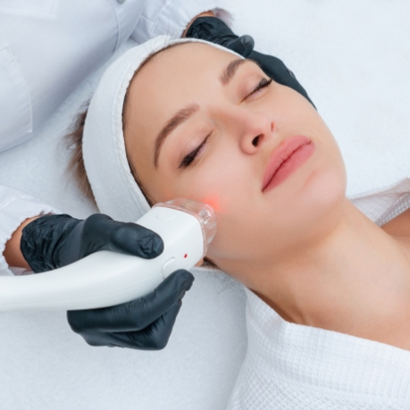 Woman having dental laser applied to her face